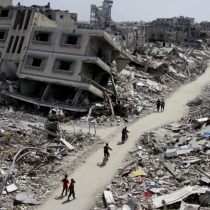 Palestinians ride bicycles past the ruins of houses and buildings destroyed during Israel’ military offensive, amid the ongoing conflict between Israel and the Palestinian Islamist group Hamas, in the northern Gaza Strip March 31, 2024. REUTERS/Mahmoud Issa.