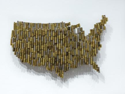 Sadat Art for Justice and Peace Wall hanging art first place by Mary Mena - bullet casings in the shape of the US